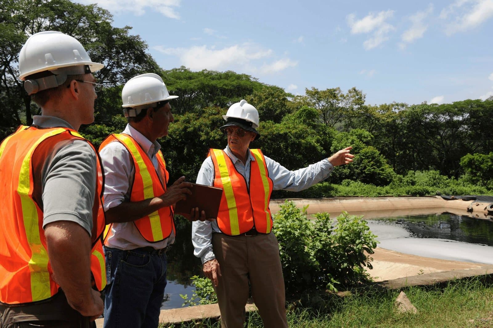 HTE engineers reviewing a site in hard hats and safety vests