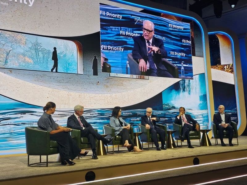 Panel discussion on stage at FII PRIORITY Miami 2026, with a speaker shown on the large screens above the panel.