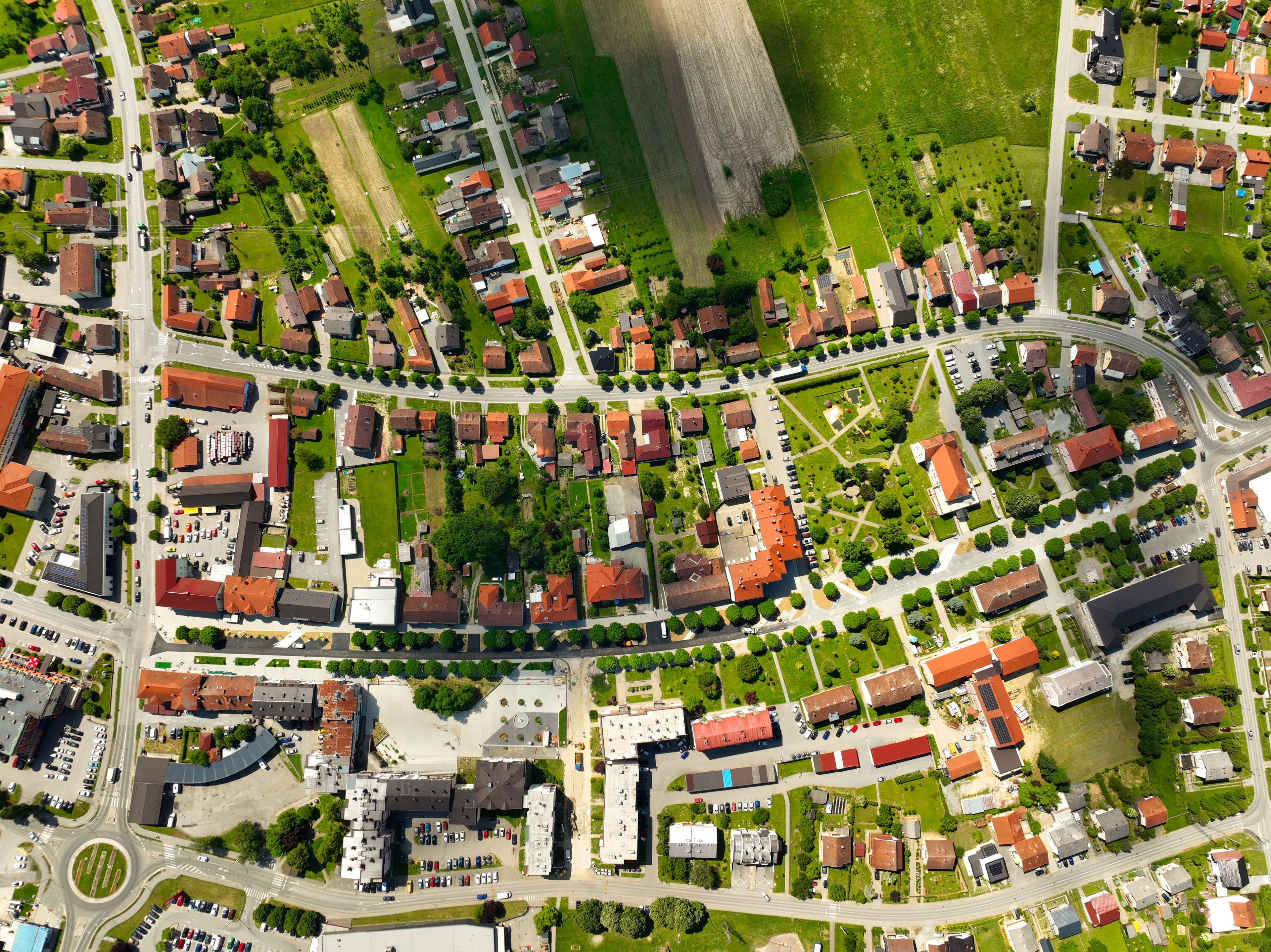 Aerial view of a town's street grid, rooftops and surrounding farmland
