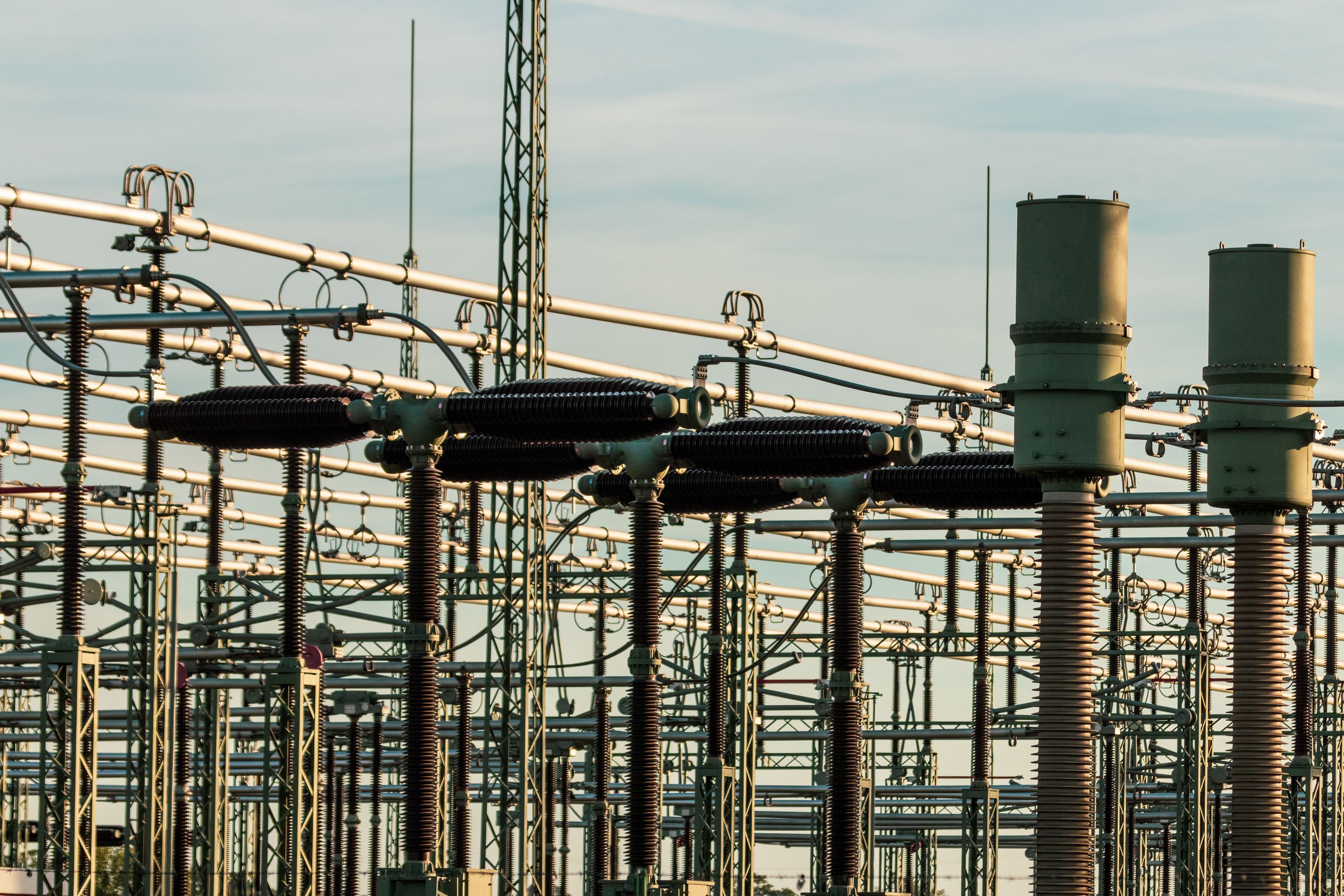 Electrical substation with rows of high-voltage insulators and transformers