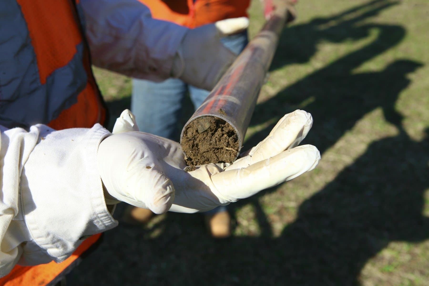 HTE field team holding a soil core sample