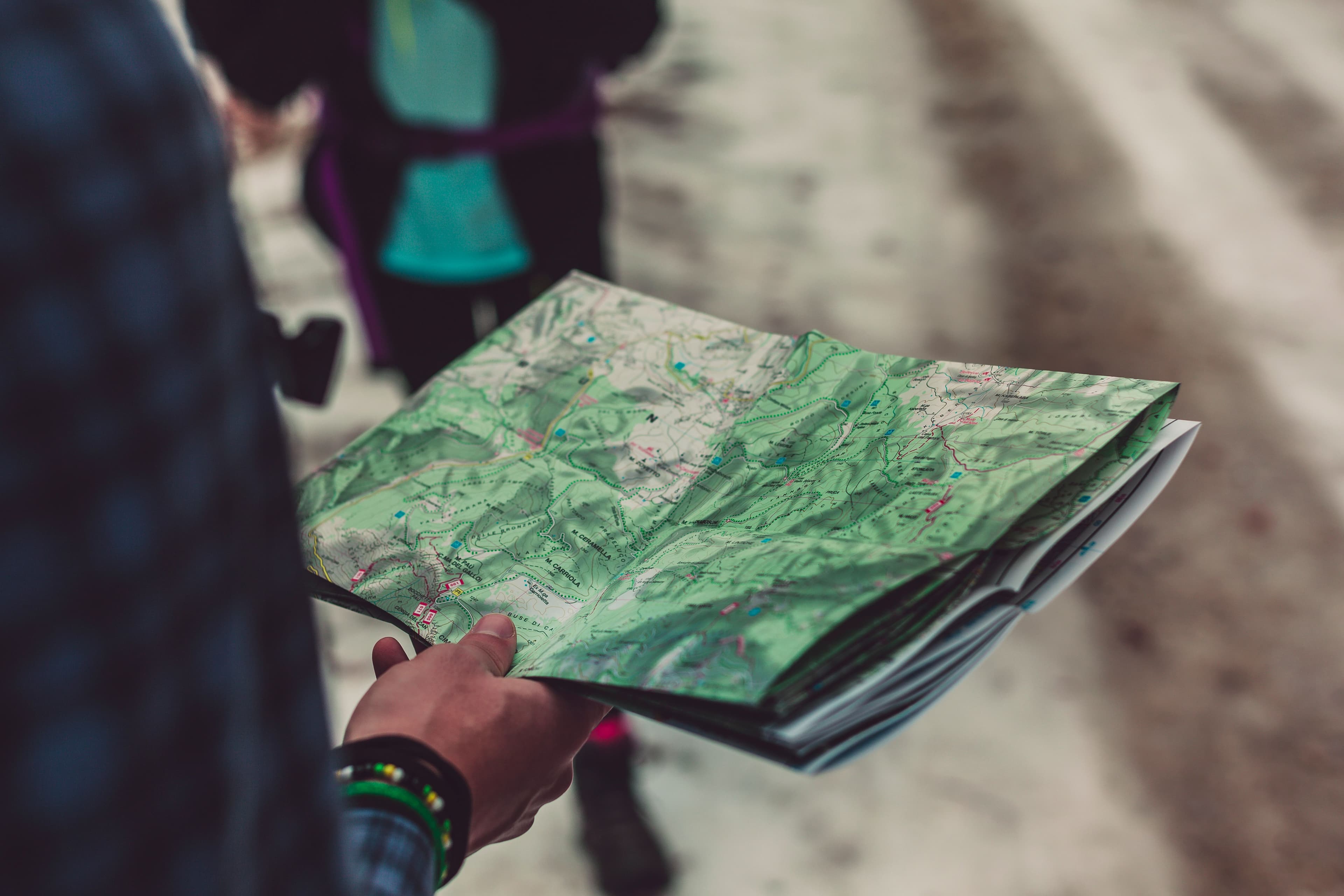 Hiker holding an open paper topographic map